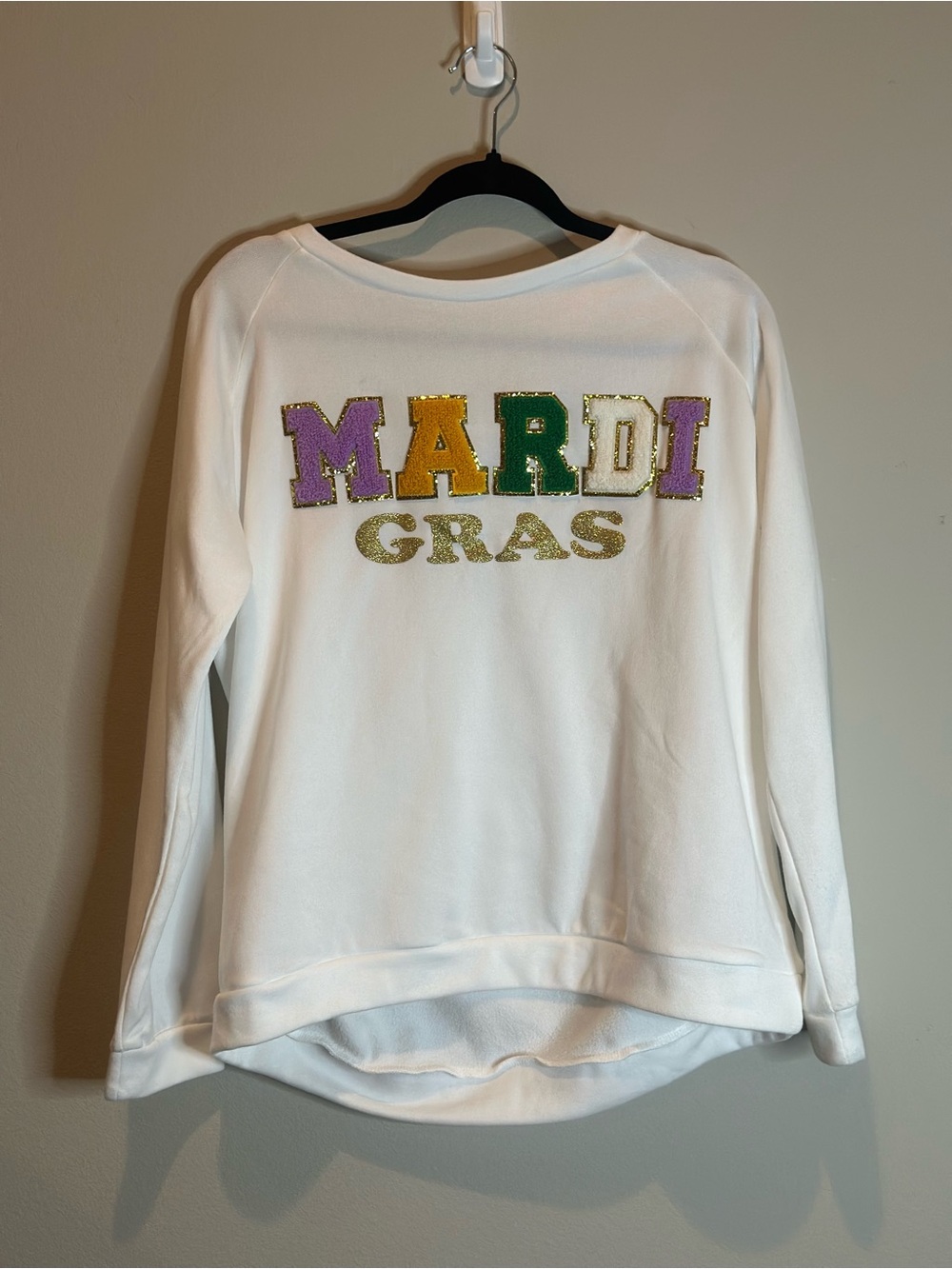 White "Mardi Gras" sweater.